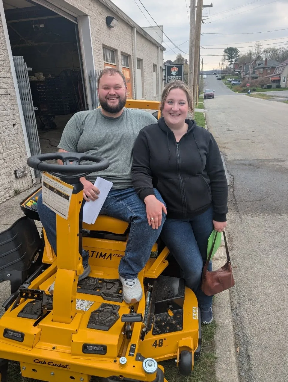 Couple with their new Cub Cadet Ultima mower outside Evergreen Equipment