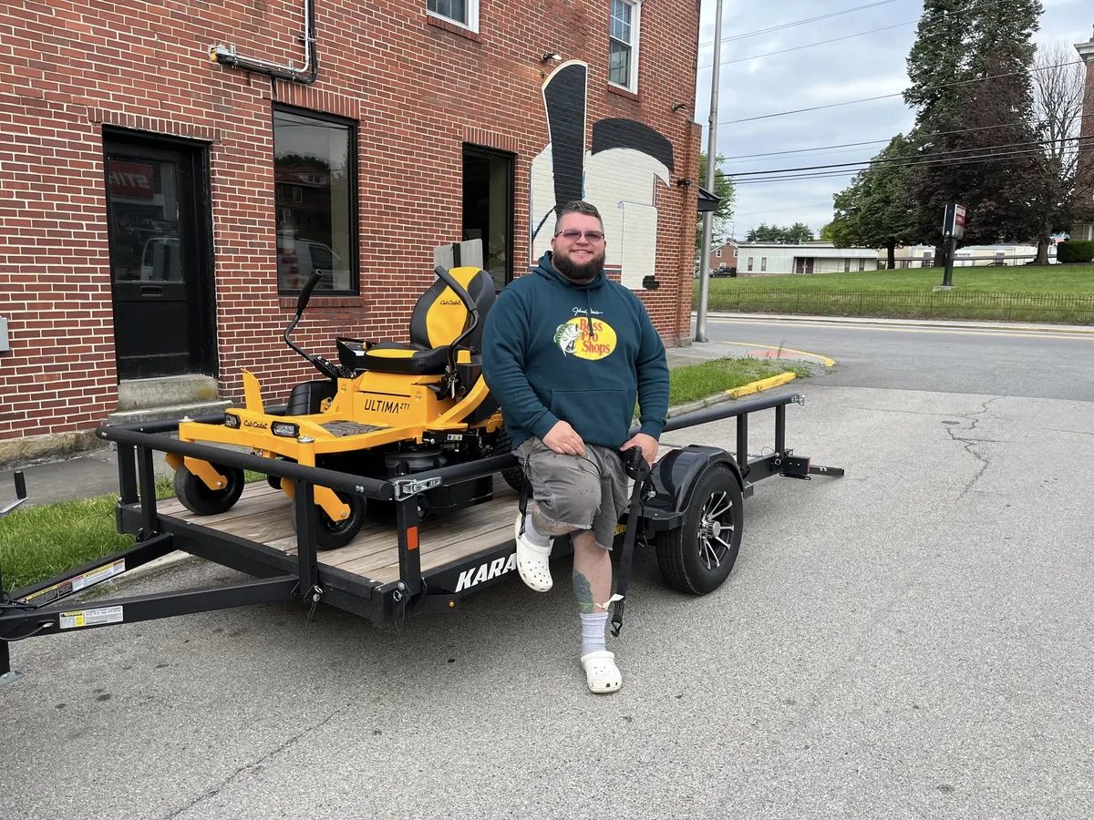 Evergreen Equipment customer with a new Cub Cadet mower on a trailer